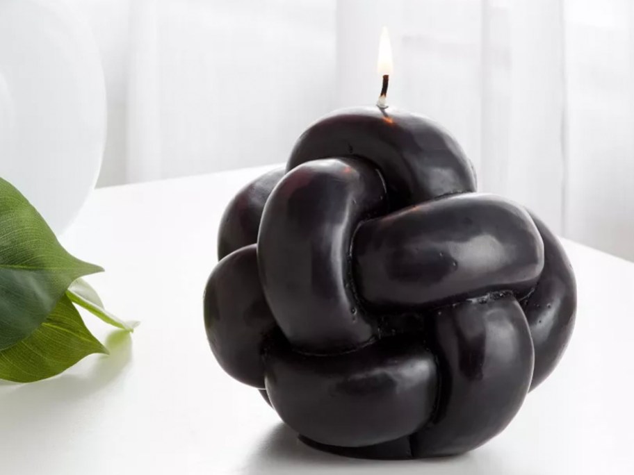 black knot candle on table