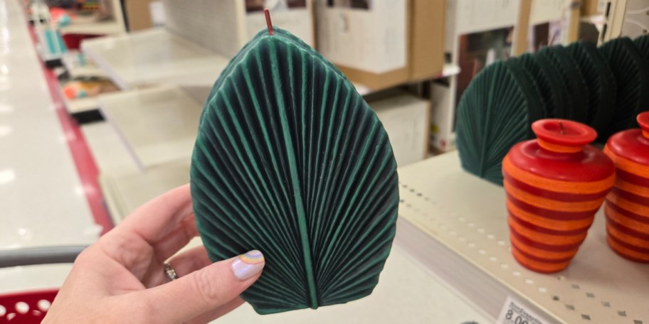 hand holding leaf candle