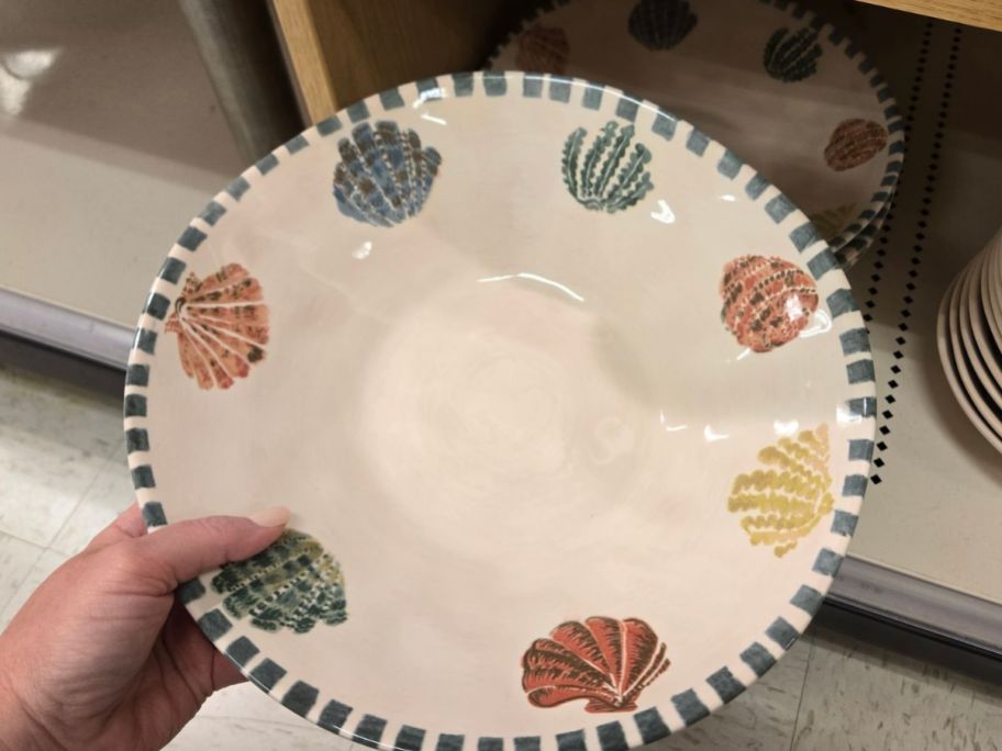 Threshold Stoneware Serving Bowl with a shell pattern on it in hand in store