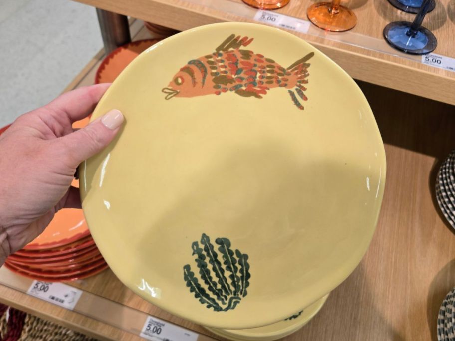 Threshold 9" Stoneware Dinner Plate with a fish on it in hand in store