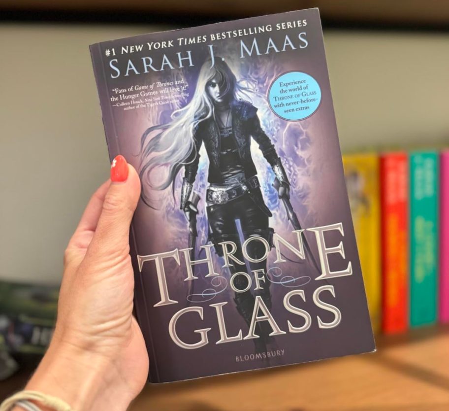 hand holding throne of glass book