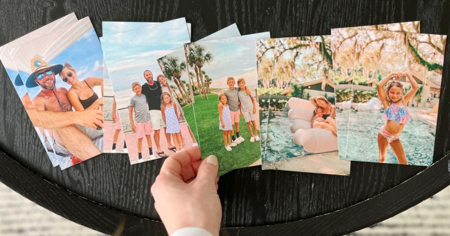 hand reaching for photo magnet off of table