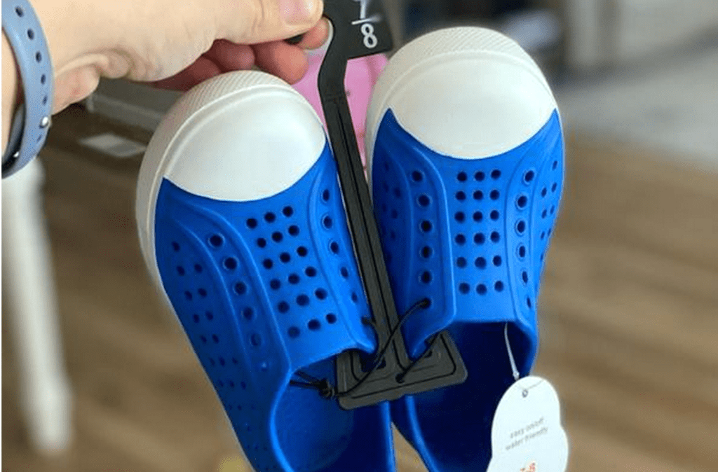 holding Walmart water shoes 