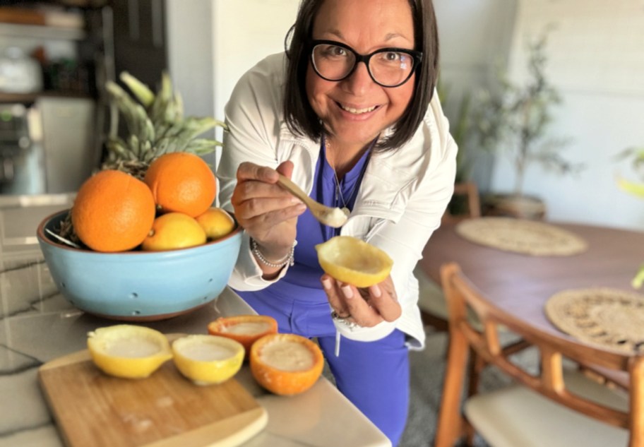 woman holding a fresh lemon sorbet