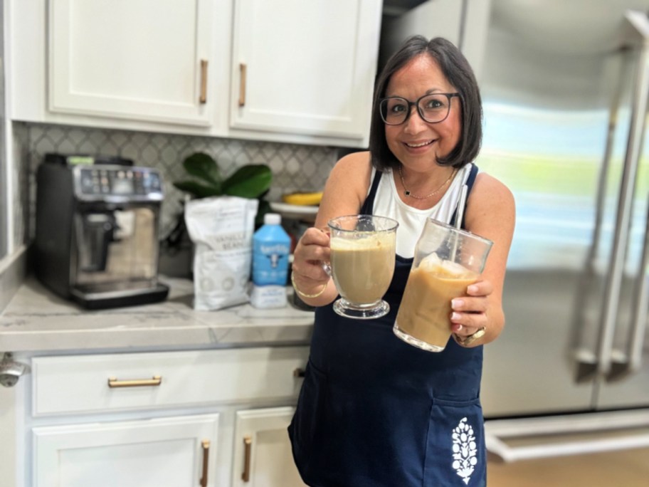 woman holding an iced protein coffee and hot proffee