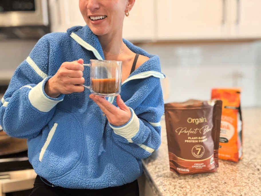 woman holding protein coffee