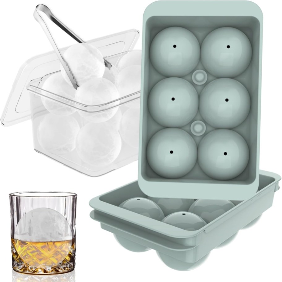 a set of round ice cube trays with a bin and tongs next to a glass with one in it