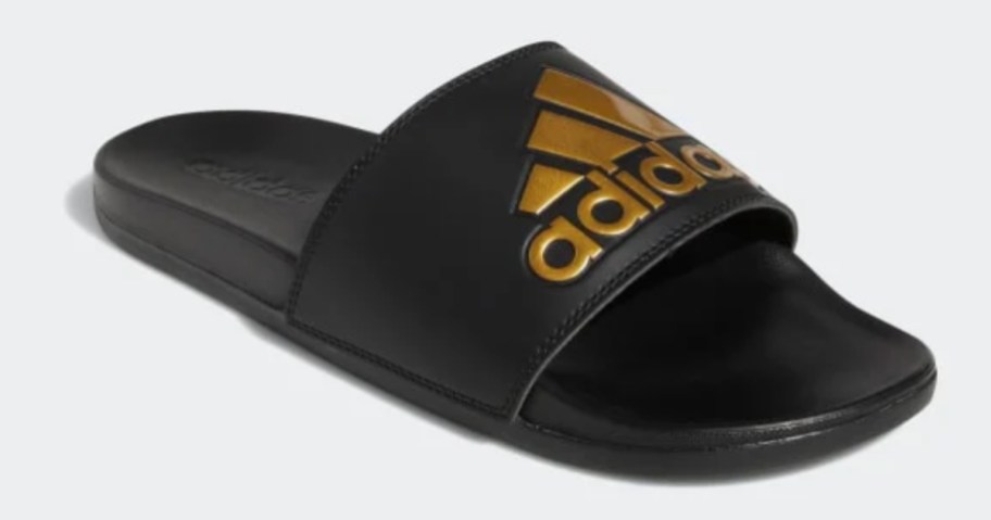 a black and gold adidas slide