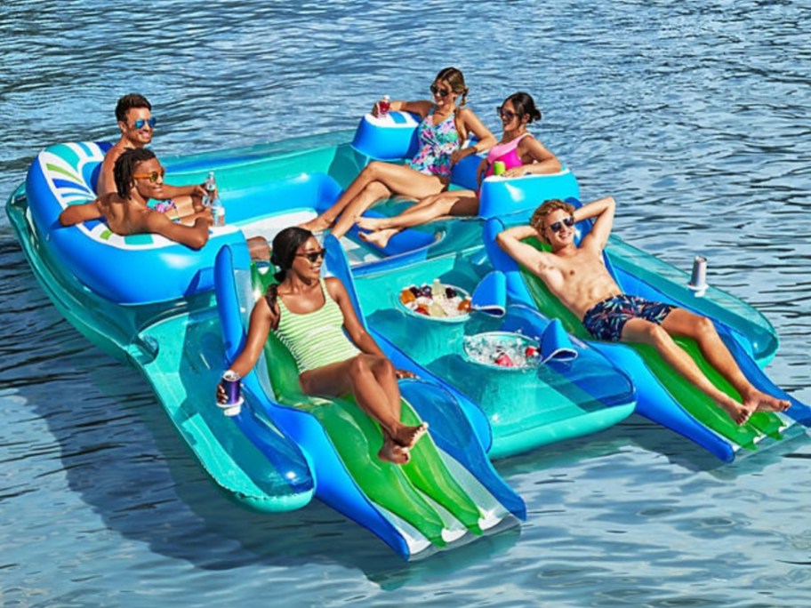 several people in an inflatable island on the water