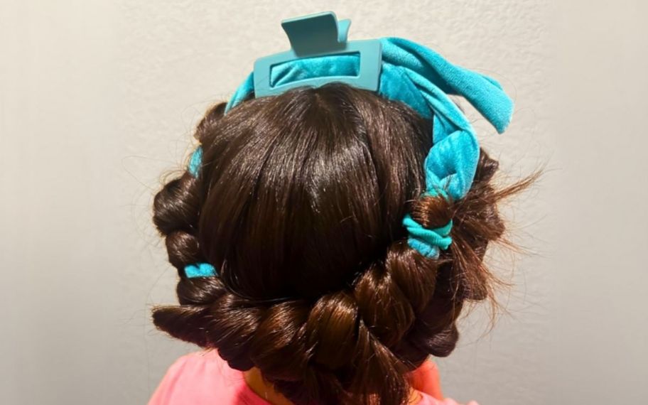 a little girl with a set of heatless curlers in her hair