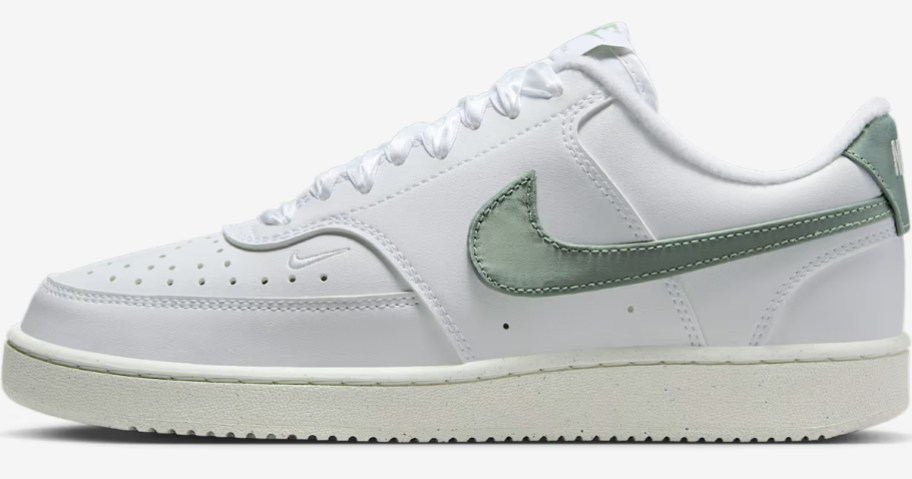 a white and green women's Nike shoe