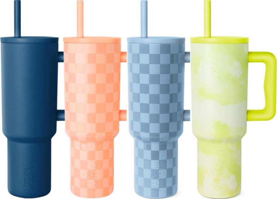four simple modern tumblers with lids and straws in assorted colors