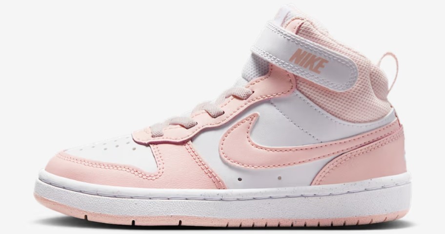 a pink and white kids Nike mid top shoe