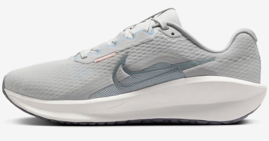 a grey and white women's Nike running shoe