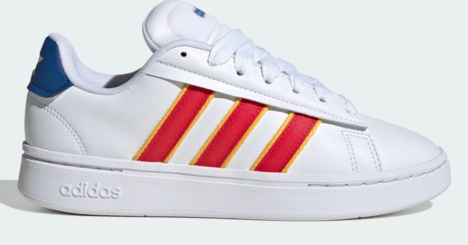 a white, orange, and blue adidas women's shoe