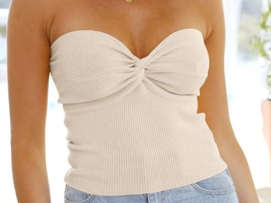 Woman wearing a beige tube top from amazon with light blue jeans
