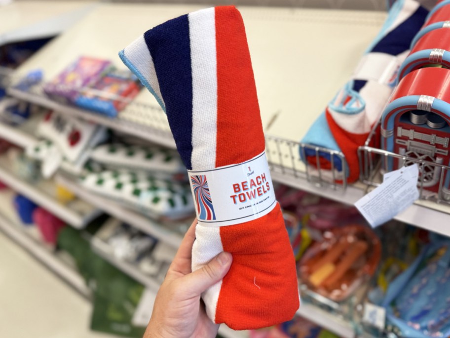 hand holding a red, white, and blue beach towel