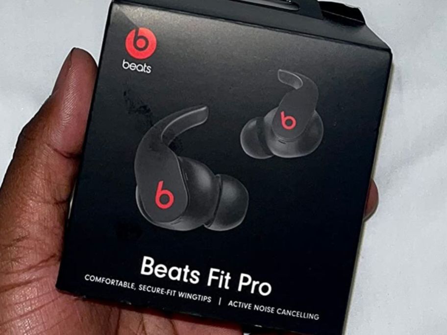 hand holding a box of Beats Fit Pro