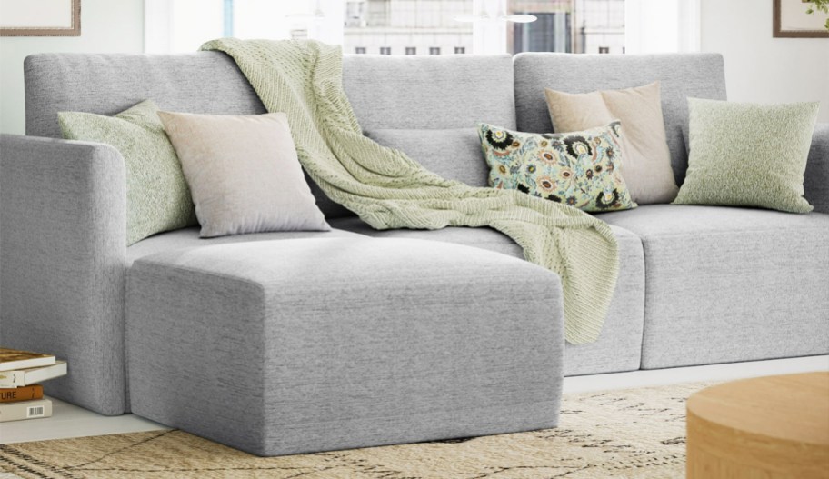 grey sofa with matching ottoman in living room