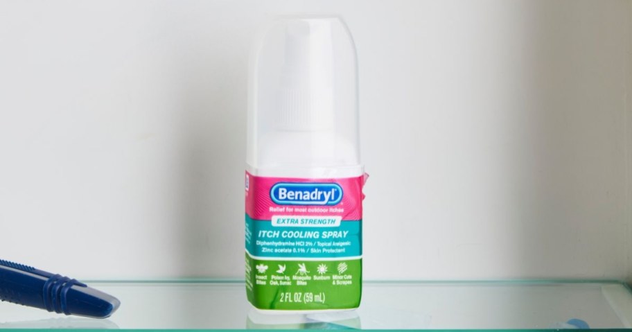 bottle of benadryl itch cooling spray on shelf in medicine cabinet