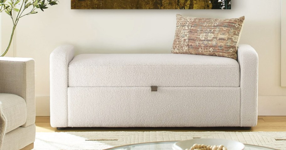 white storage bench with throw pillow on top