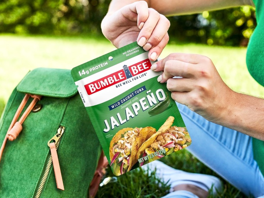 woman opening a pouch of Bumble Bee Jalapeño Tuna