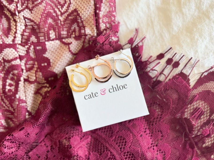three different finish hoops displayed on top of a lacy shirt