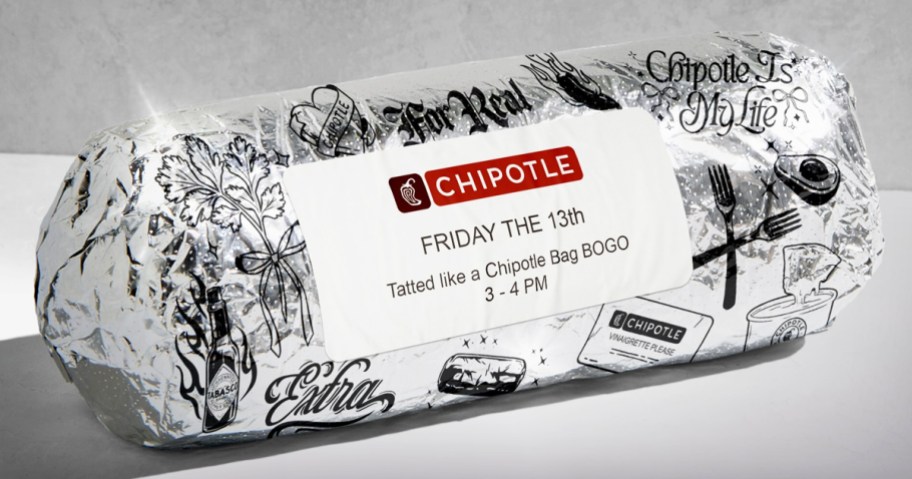 Chipotle burrito wrapped in foil with tattoo designs on it