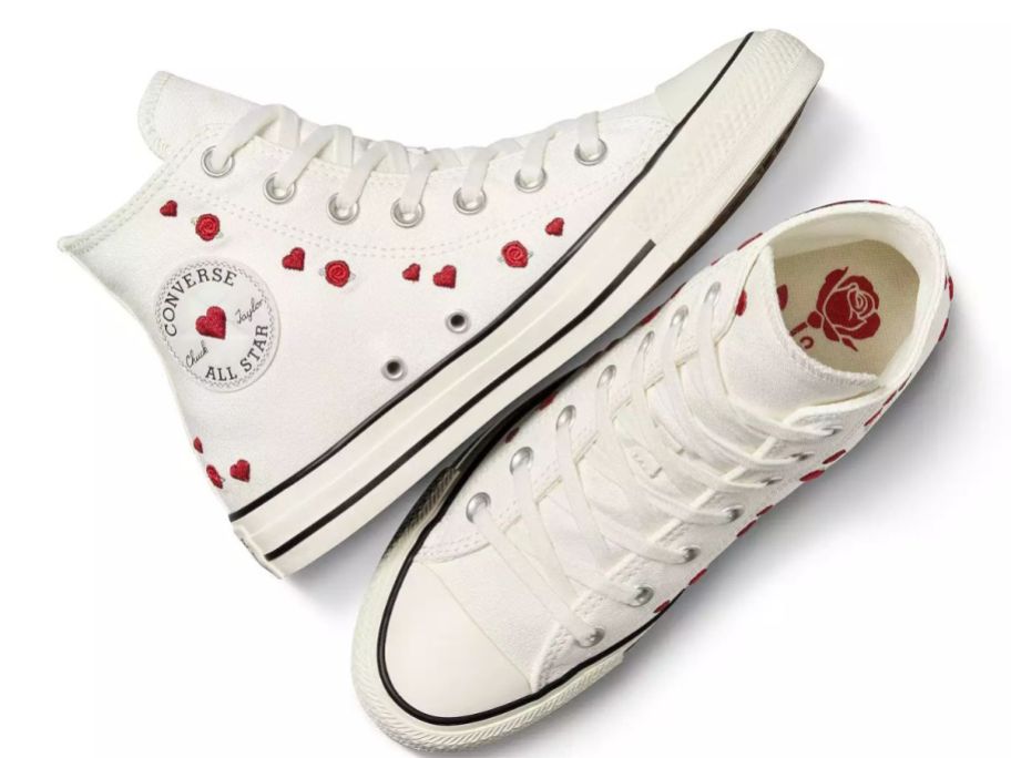 A pair of white Converse sneakers with hearts on them