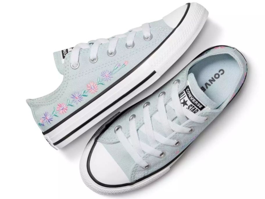 A pair of blue floral Converse sneakers