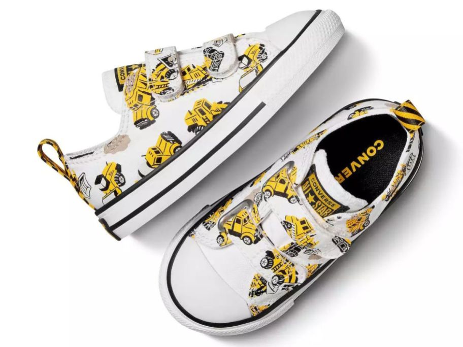 A pair of little boy's Converse sneakers with construction vehicles on it 