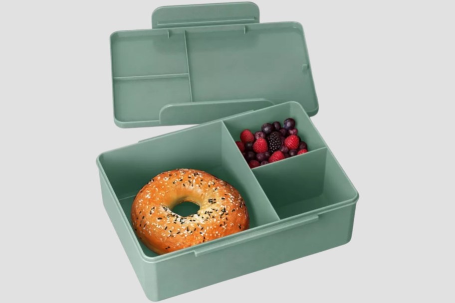 green dealworthy bento box with bagel and berries inside