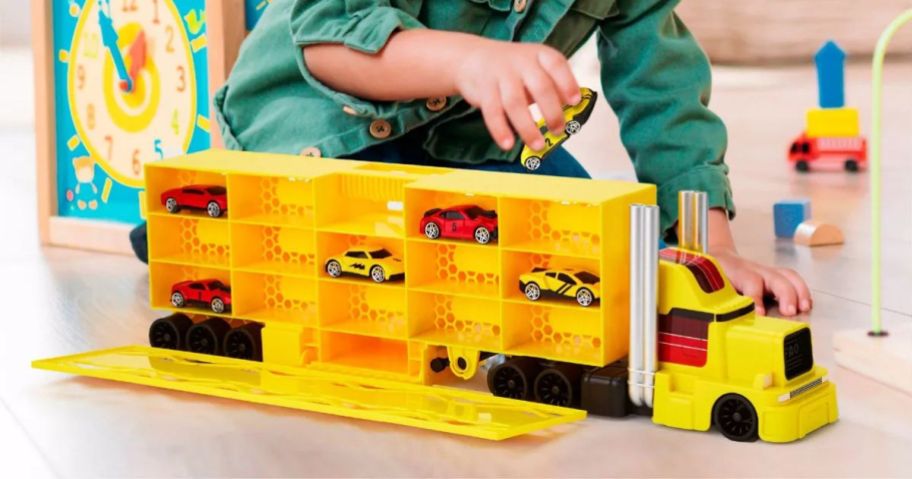 A child playing with a large truck toy