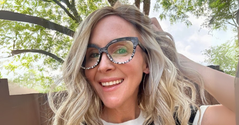 Collin (woman with blond hair) wearing a black and white pair of glasses