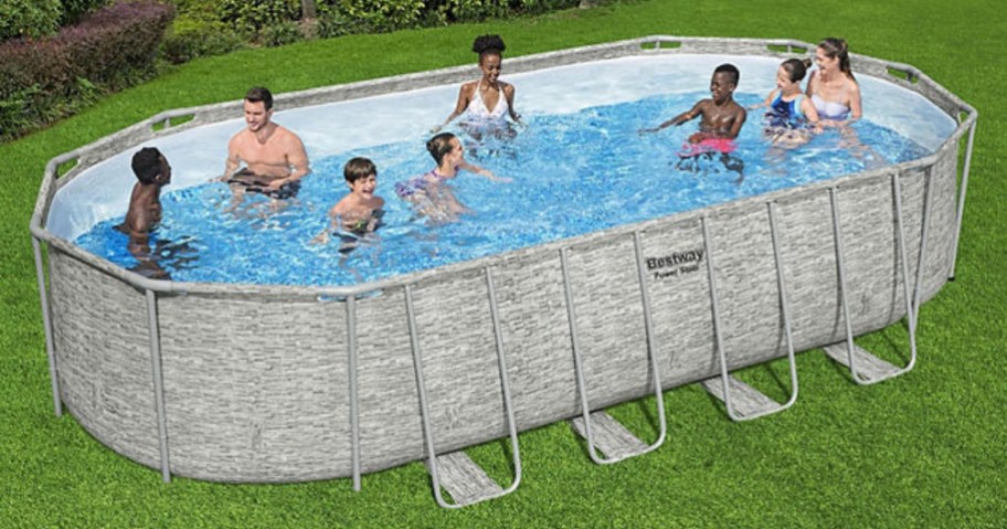 a family in an above ground pool in a backyard