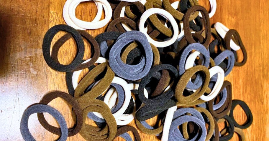 a small pile of hair ties on a wood table