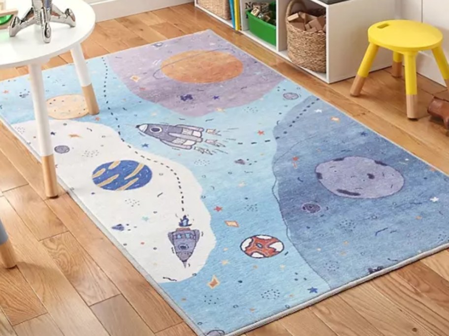 a kids activity rug with an outerspace design in a playroom