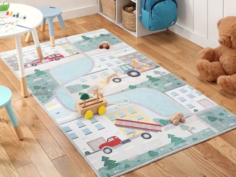a kids activity rug with vehicles and roads on a playroom floor