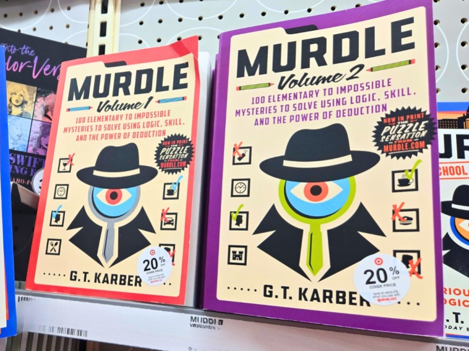 2 Murdle mystery puzzle books on a store shelf