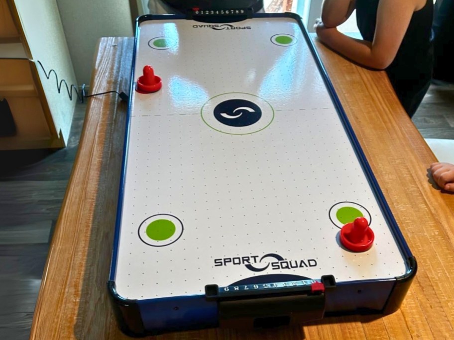 a table top air hockey table game on top of a table