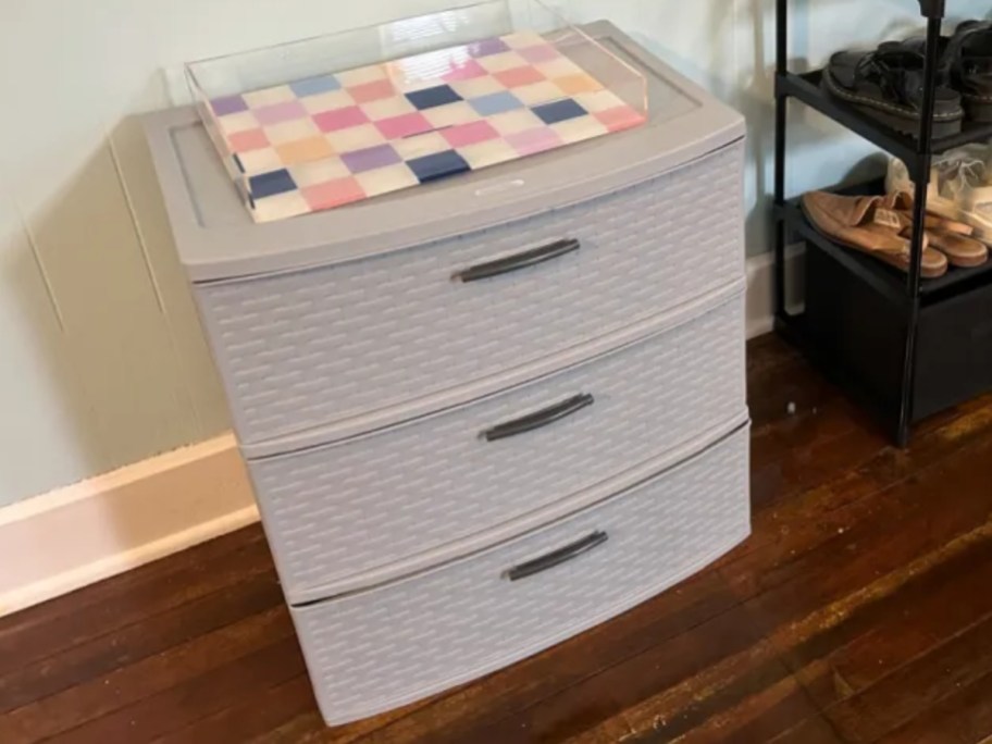 grey plastic 3-drawer storage organizer with a checkered acrylic tray on top