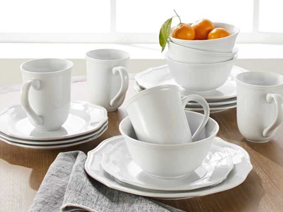 a set of white dinnerware on a table