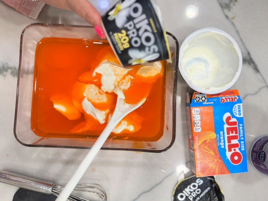 mixing greek yogurt with orange jello 