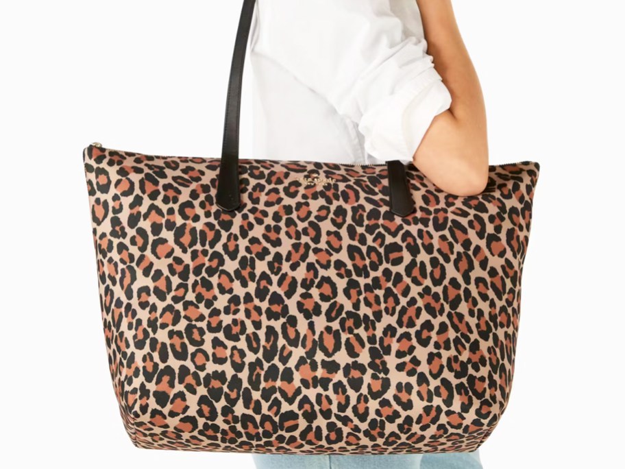 woman carrying a large leopard print tote bag