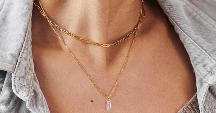woman wearing a layered necklace with tourmaline pendant 