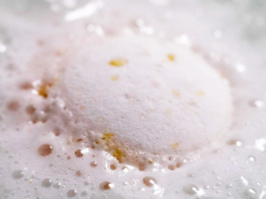 white bath bomb dissolving in water