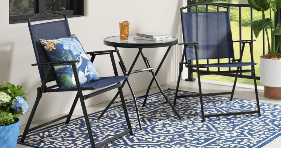 blue patio chairs with glass bistro table