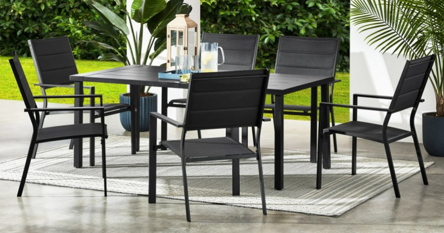 6 black metal chairs around a patio dining table