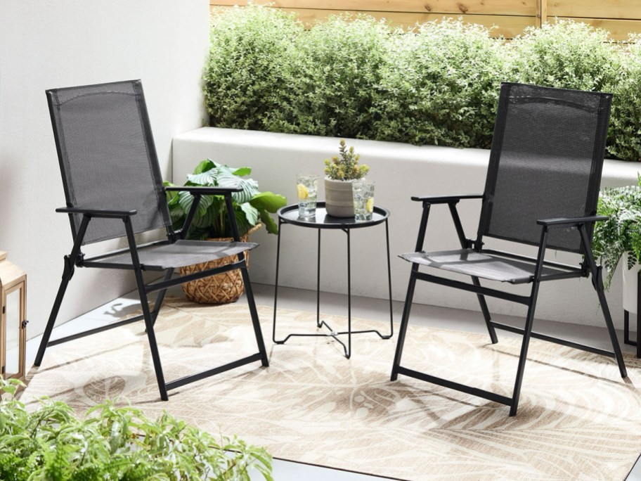 black patio chairs with black side table