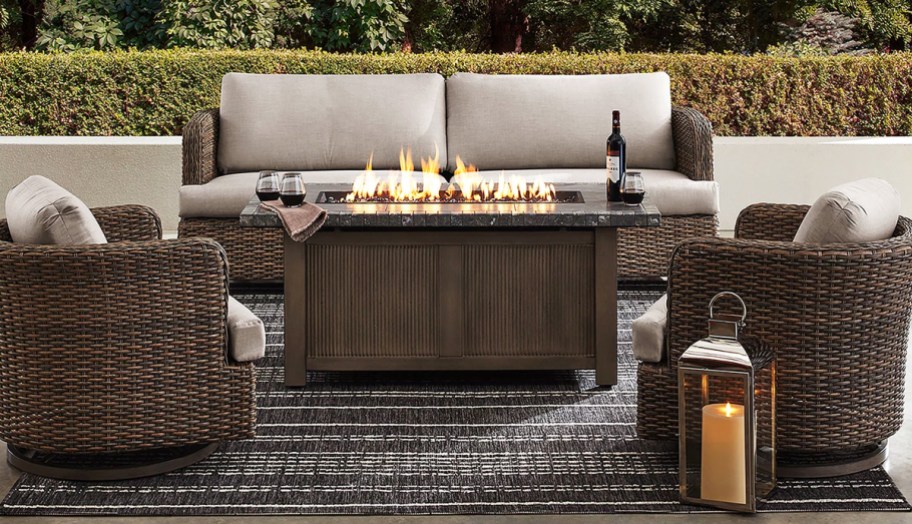 two patio chairs and loveseat around a rectangular fire pit